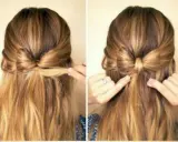 Coiffure fille rentrée scolaire : un joli chignon nœud pour un look chic et pratique.