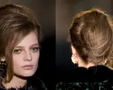 Chignon banane décoiffé, un style chic et décontracté, avec quelques mèches rebelles encadrant le visage.