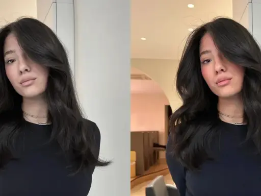 Une jeune femme aux cheveux bruns et brillants, pose avec un sourire subtil. Elle porte un col roulé noir et des colliers fins. On se demande combien de temps dure un gloss cheveux pour obtenir un tel éclat.