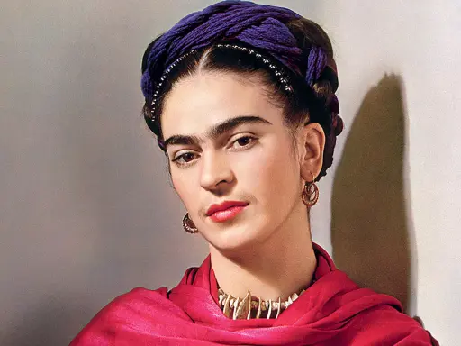 Portrait de Frida Kahlo avec sa célèbre coiffure torsadée violette, un foulard rouge vif et des bijoux ethniques.