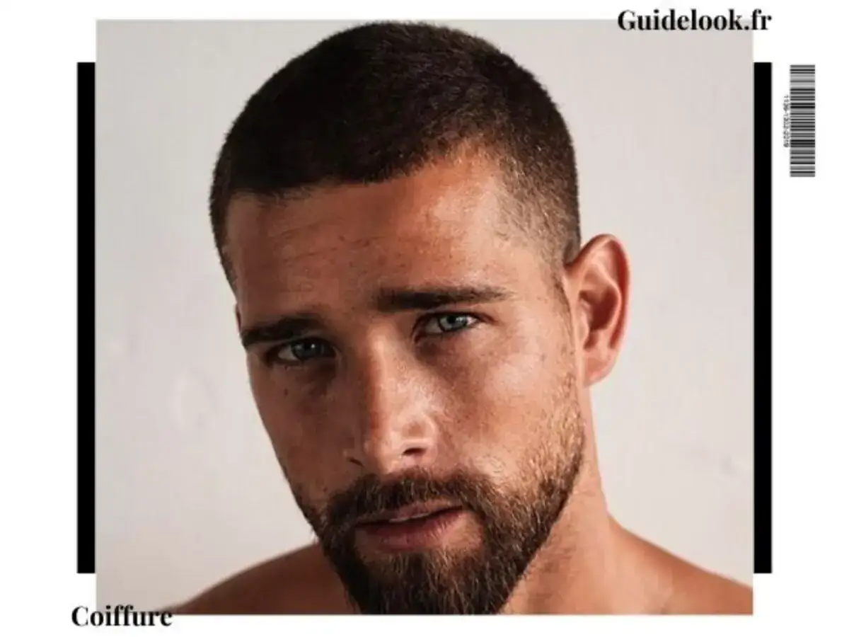 Un homme au regard intense arbore une coupe buzz cut impeccable, soulignant son style audacieux.
